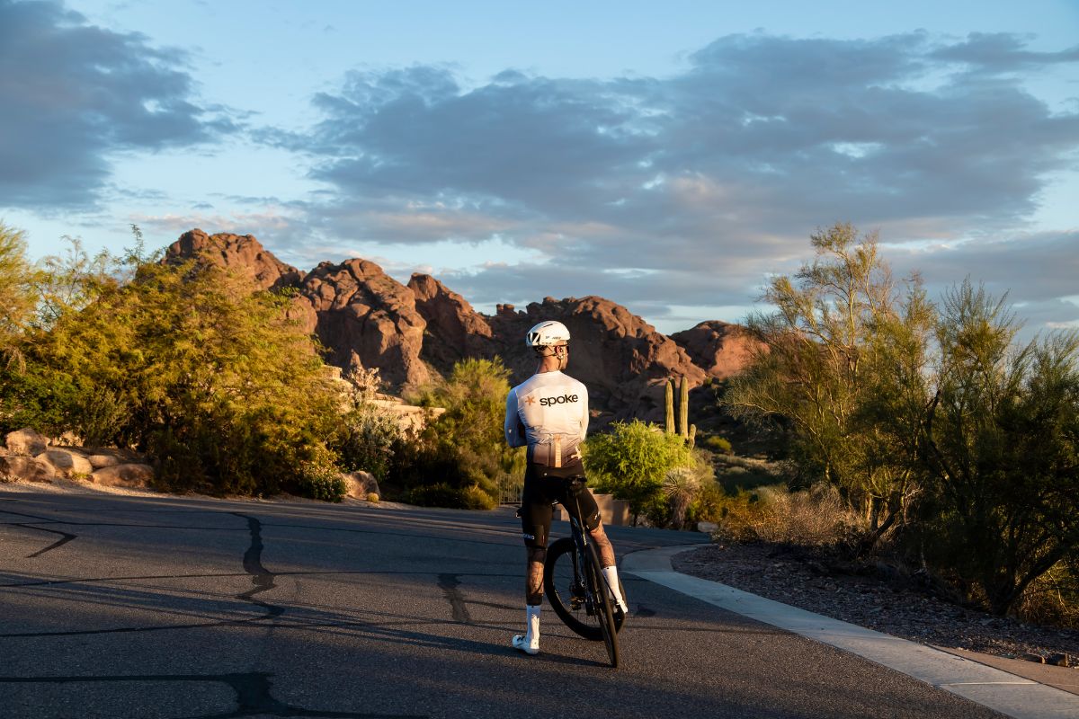 Cyclist riding on a road at sunset